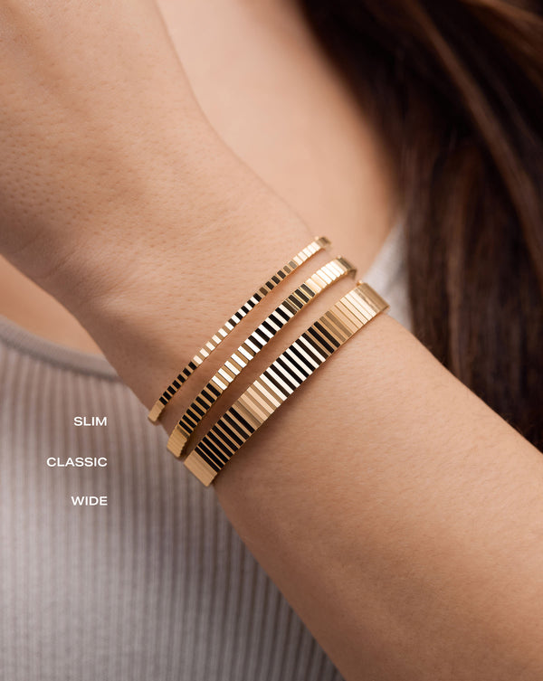 Fluted Gold Bangle, on model stacked in sizes slim, classic and wide