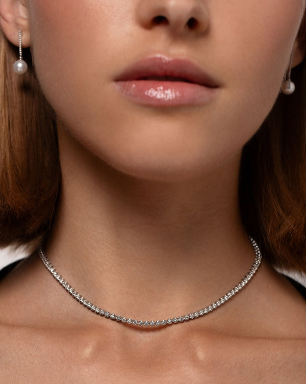 diamond tennis necklace, diamond and pearl drop earrings on model