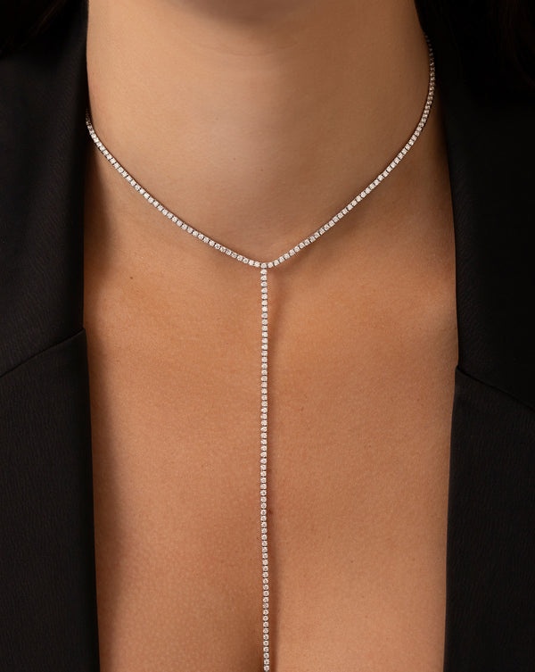 Close up image of the diamond lariat necklace on neck of model