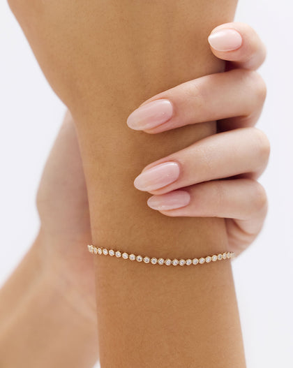 Close-up view of Bezel Mini Diamond Tennis Bracelet showing individual diamond bezels and gold links