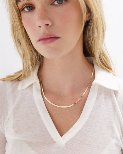14k yellow gold herringbone chain necklace 3mm width displayed on white background