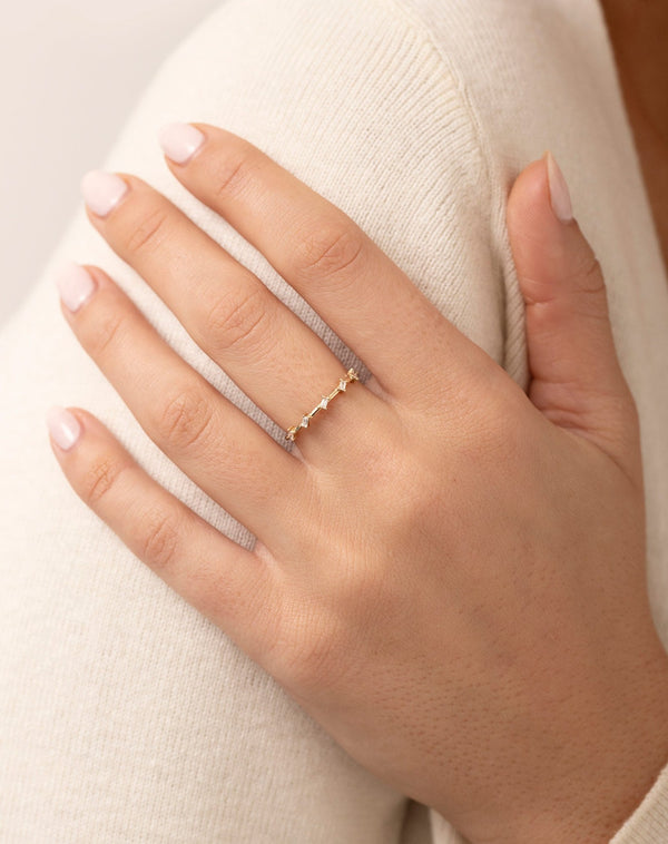 Baguette Distance Ring shown on middle finger of model