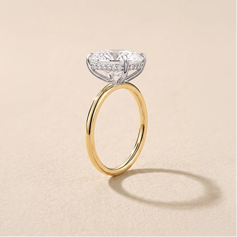 whisper thin engagement ring against a travertine background