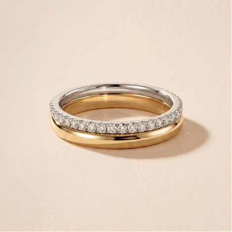 stacked wedding bands against a travertine background