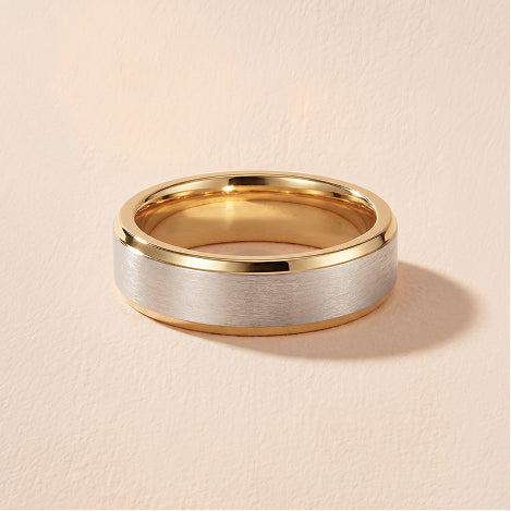 contrast edge mens wedding band against a travertine background