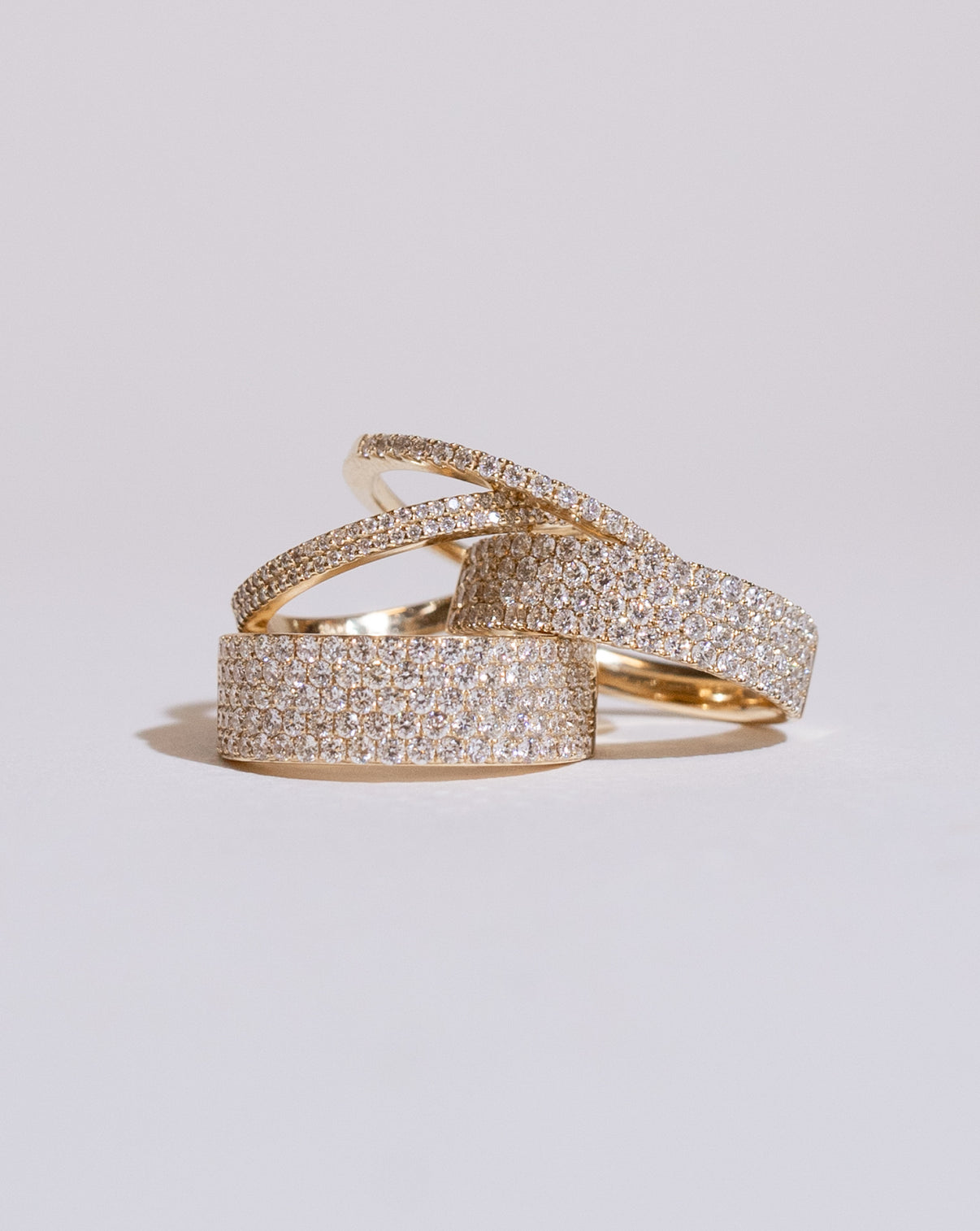 Ring Concierge Rings Five Row Stackable Pavé Ring stacked with four row stackable pave ring, two row stackable pave ring and stackable pave ring