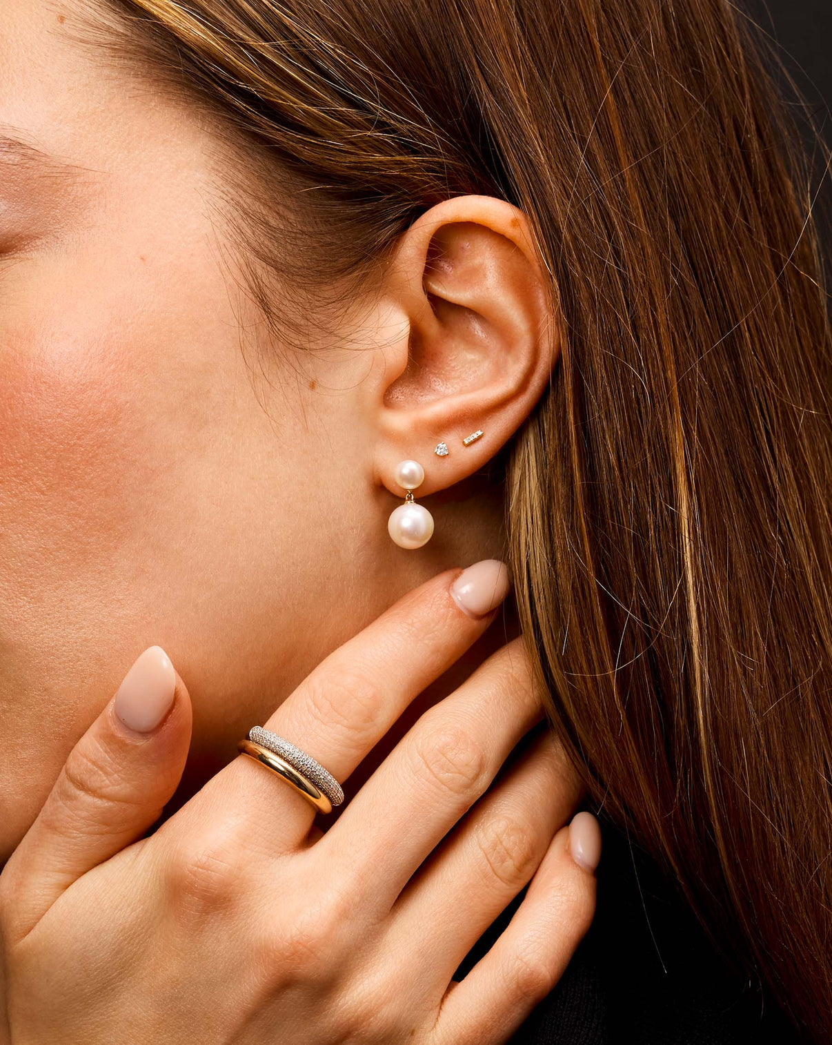 Pearl Duo Dangle Earrings on model with 2 other studs