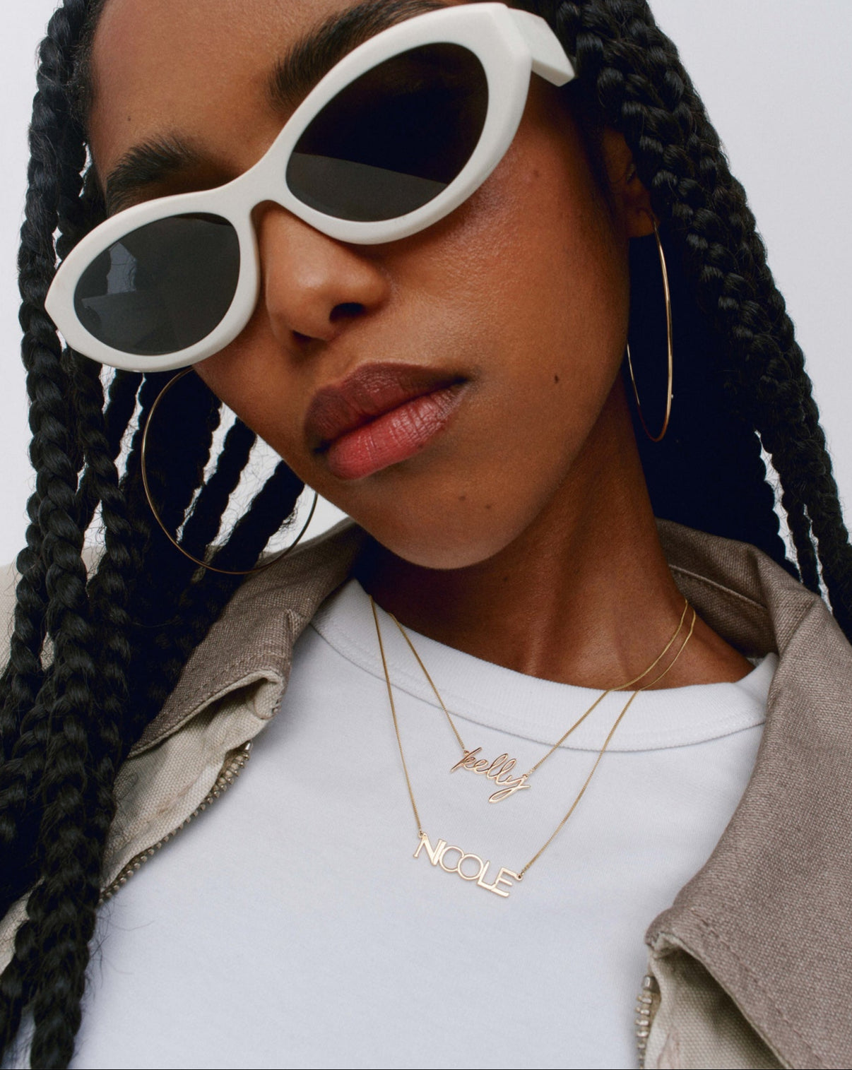 Personalized Block Name Necklace and Personalized Script Name Necklace styled on model with sunglasses global