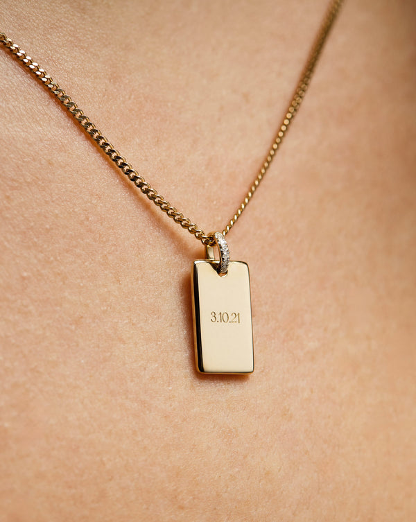 Model wearing Yellow Gold Engravable Rectangle Pendant on Yellow Gold Diamond Cut Curb Chain Necklace.