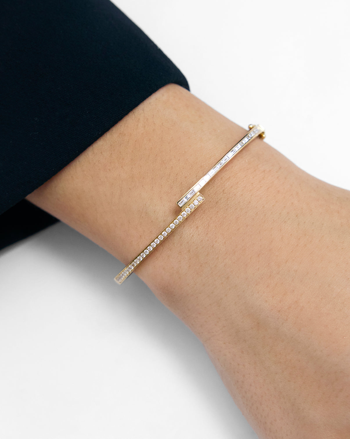 Baguette + Round Diamond Wrap Bangle in 14k gold shown shown on wrist, highlighting the alternating baguette and round diamond setting