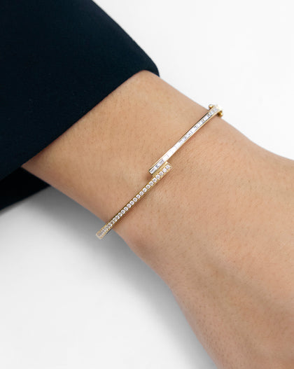 Baguette + Round Diamond Wrap Bangle in 14k gold shown shown on wrist, highlighting the alternating baguette and round diamond setting