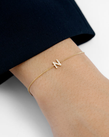 Close-up detail of Diamond Initial Bracelet showing diamond-set letter and 14k gold chain