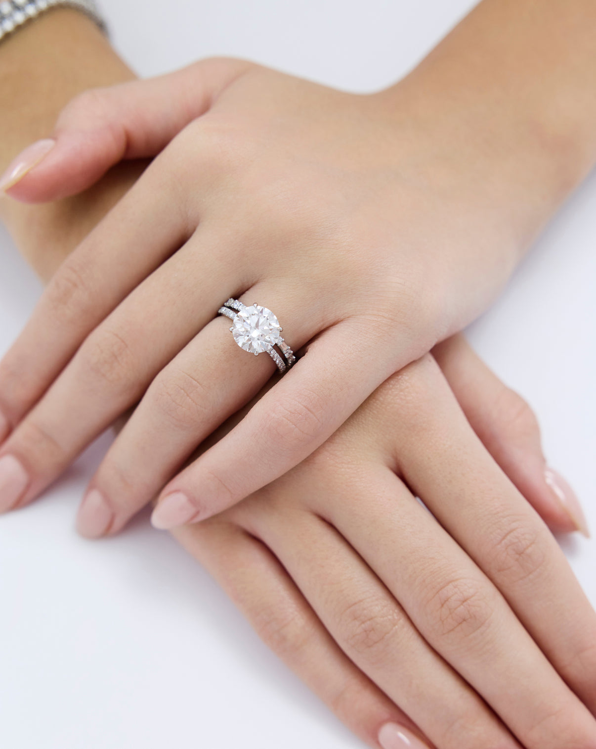 Ring Concierge Baguette + Round Eternity Band Platinum on model paired with round engagement ring