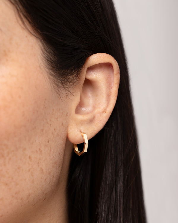 Gold Faceted Huggies shown close up on ear of model