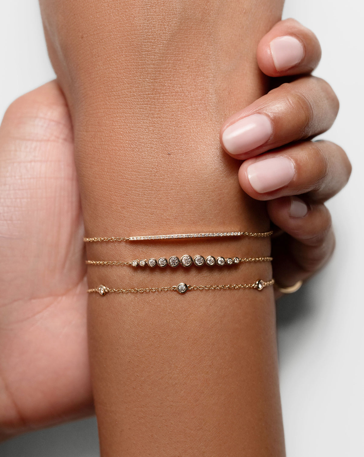 Graduated Diamond Bezel Soft Chain Bracelet on model styled with 2 other bracelets