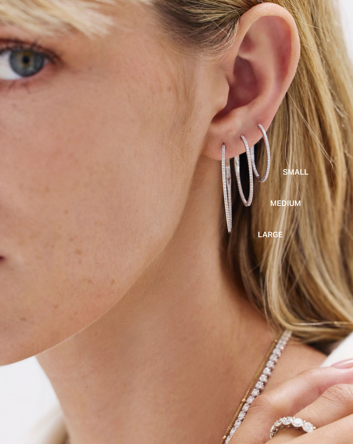 Diamond hoop earrings styled on model ear for size reference and appeal