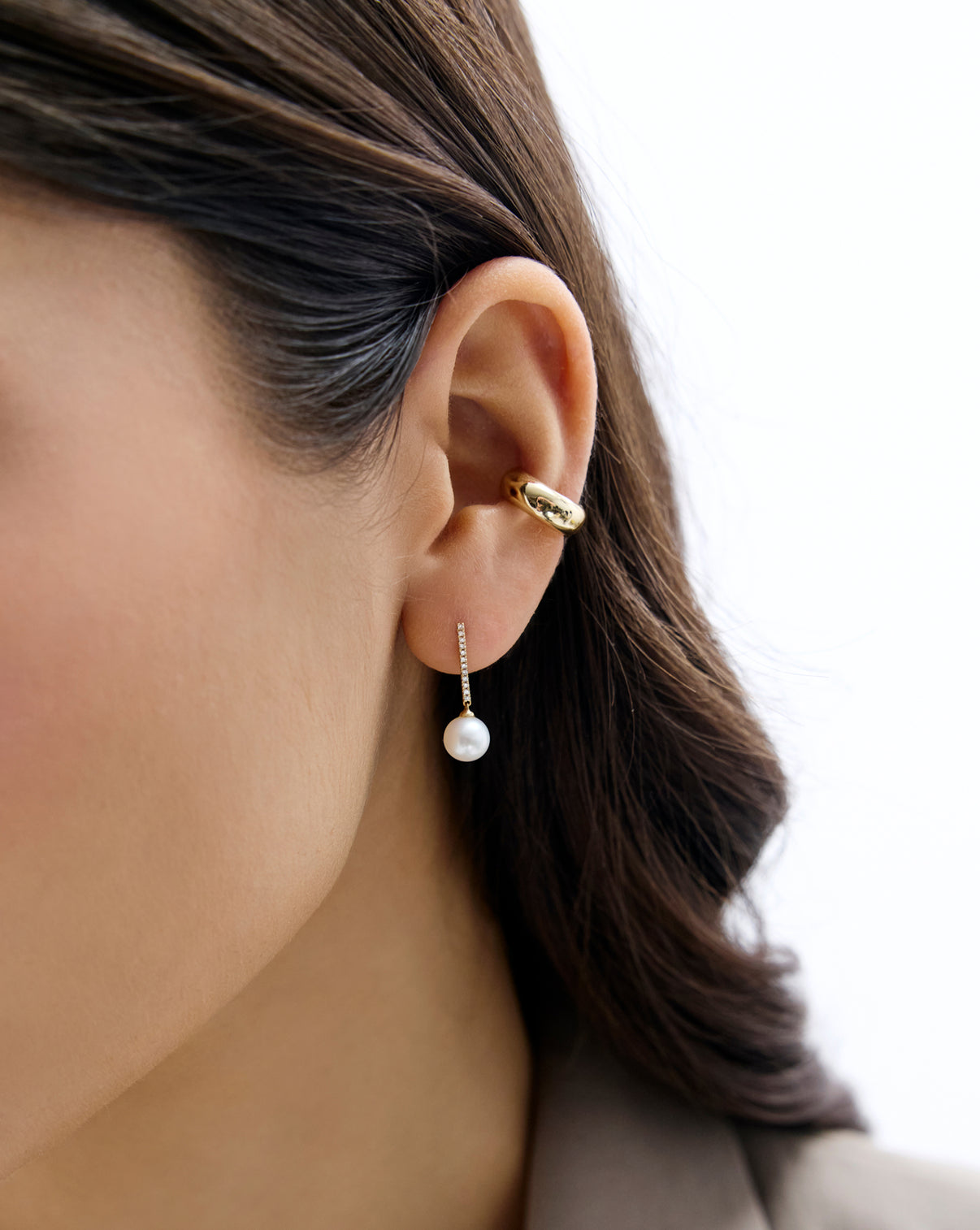 Close up of model wearing Diamond and Pearl Drop Earrings in 14K Yellow Gold
