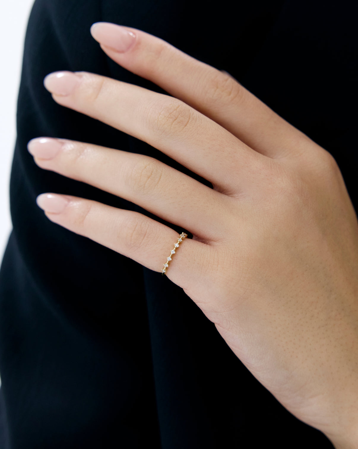 Diamond Station Stackable Ring with 11 round natural diamonds worn by model on hand