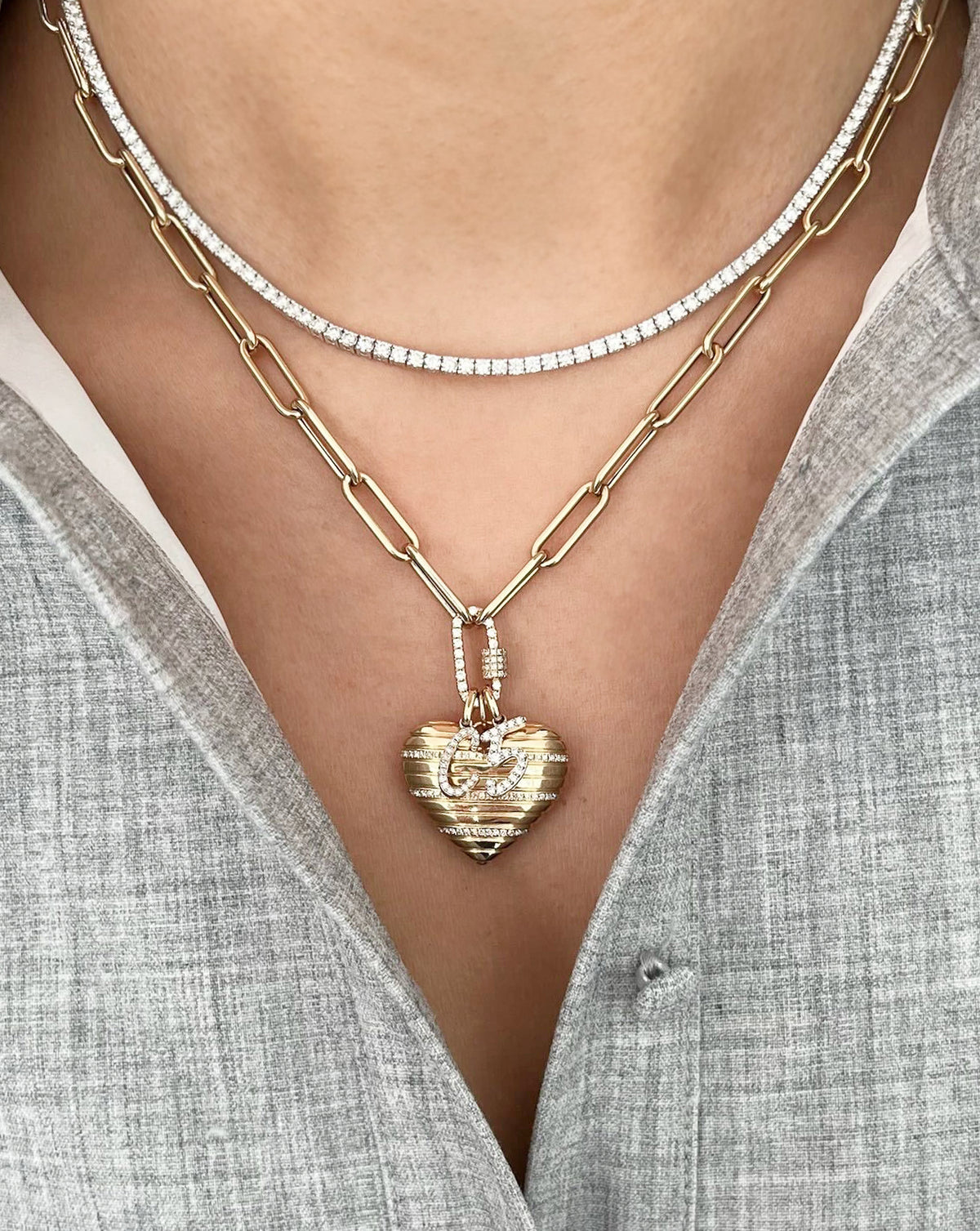 on-model image of heart pendant with chain in yellow gold stacked with tennis necklace