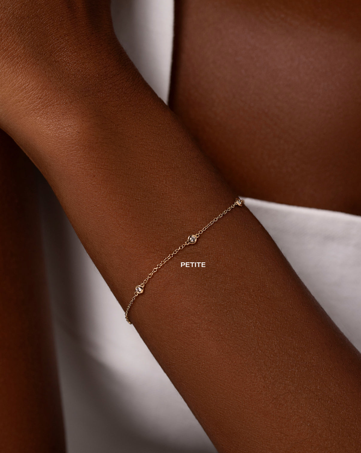 petite bezel-set round diamond tennis bracelet on model global PETITE