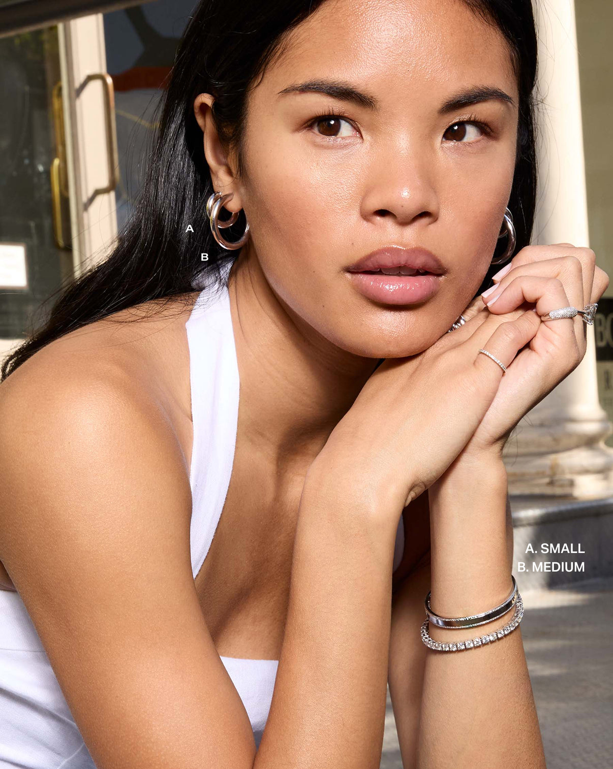 on-model image wearing multiple sizes of hoops global
