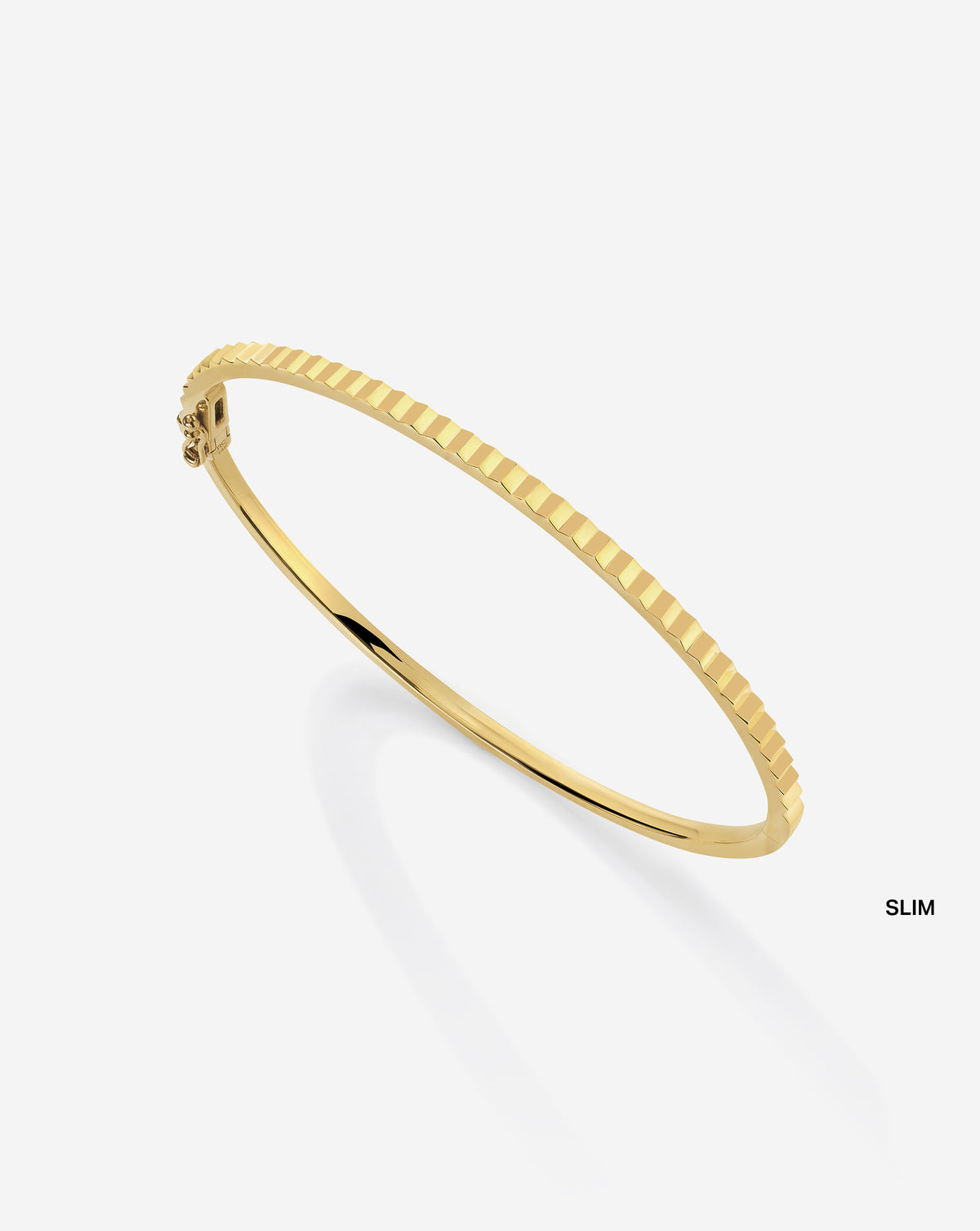 Close-up detail of Slim Fluted Gold Bangle showing intricate ridged texture and lustrous gold finish