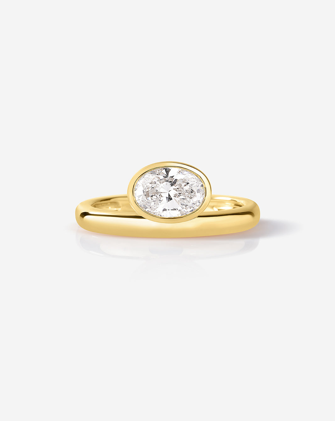 Oval bezel ring in 14k yellow gold featuring 0.78 carat G-H VS lab diamond in sleek bezel setting