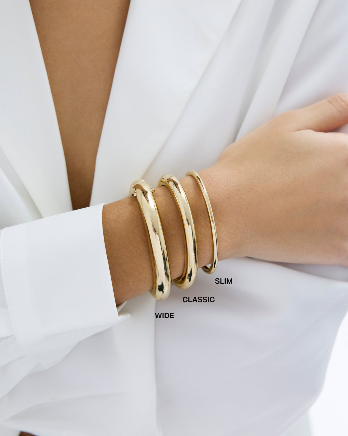 Stackable Gold Cloud Bangle bracelet in 14k yellow gold shown on model's wrist in all three sizes, slim, classic and wide