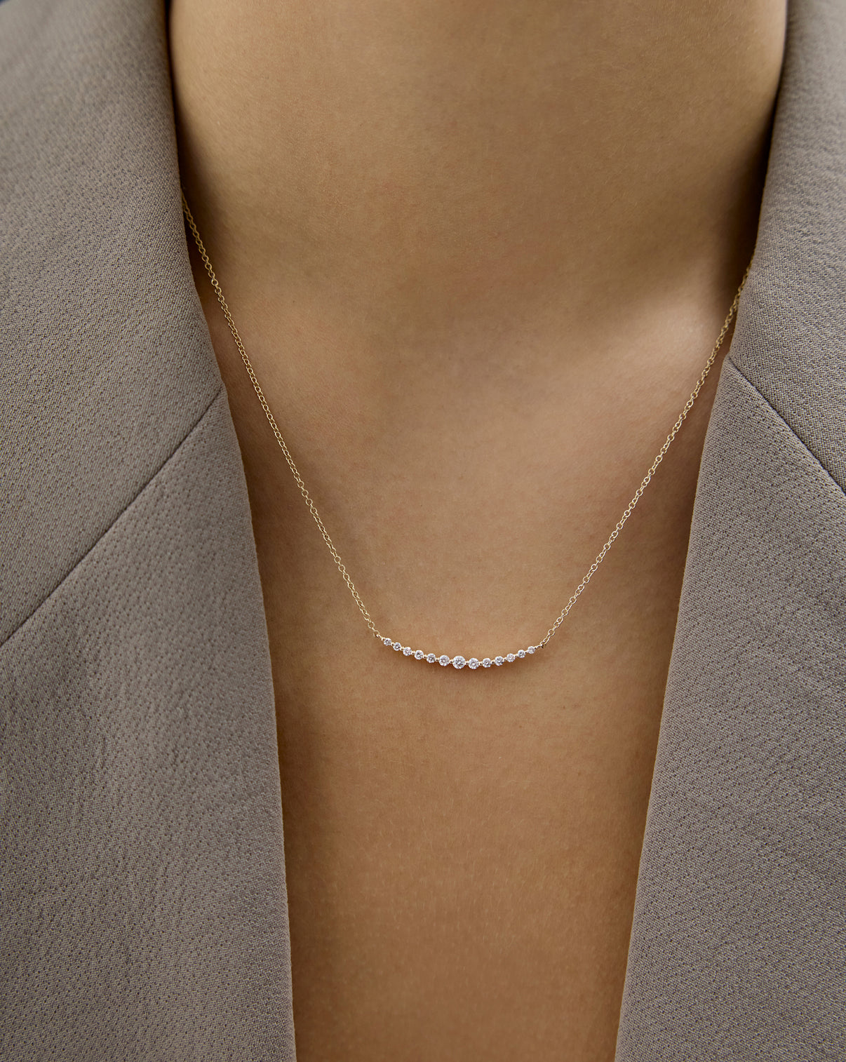 Graduated single prong diamond necklace on model global