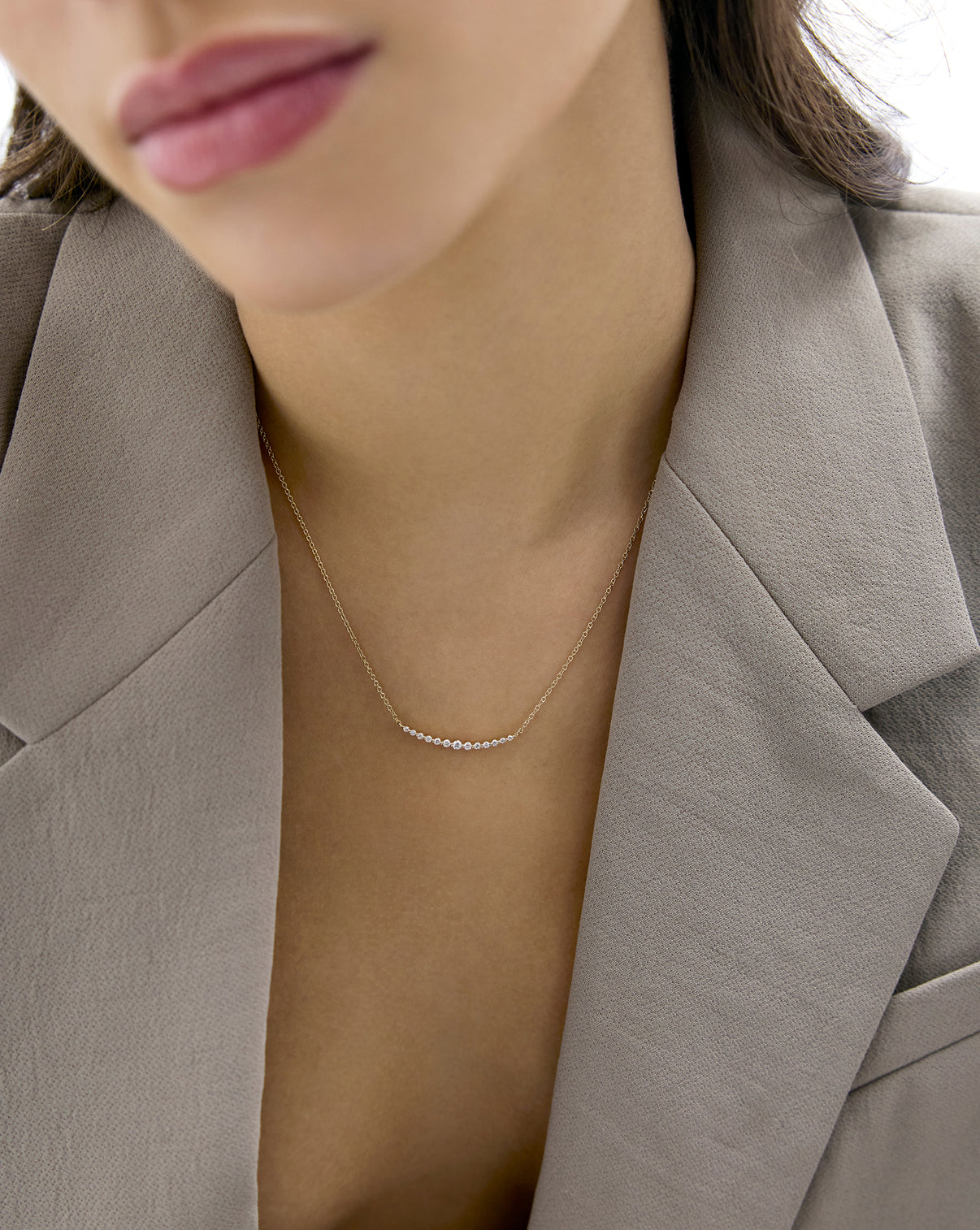 Graduated single prong diamond necklace worn by model global