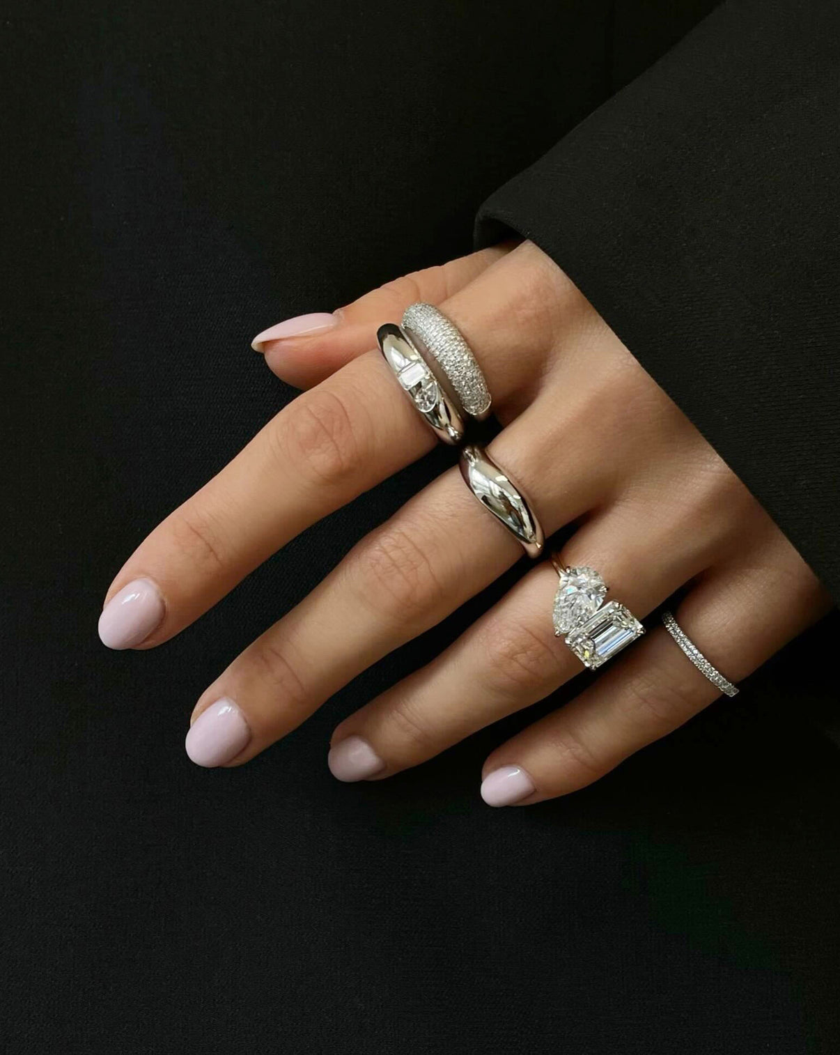 Toi et Moi engagement ring on model styled with other rings