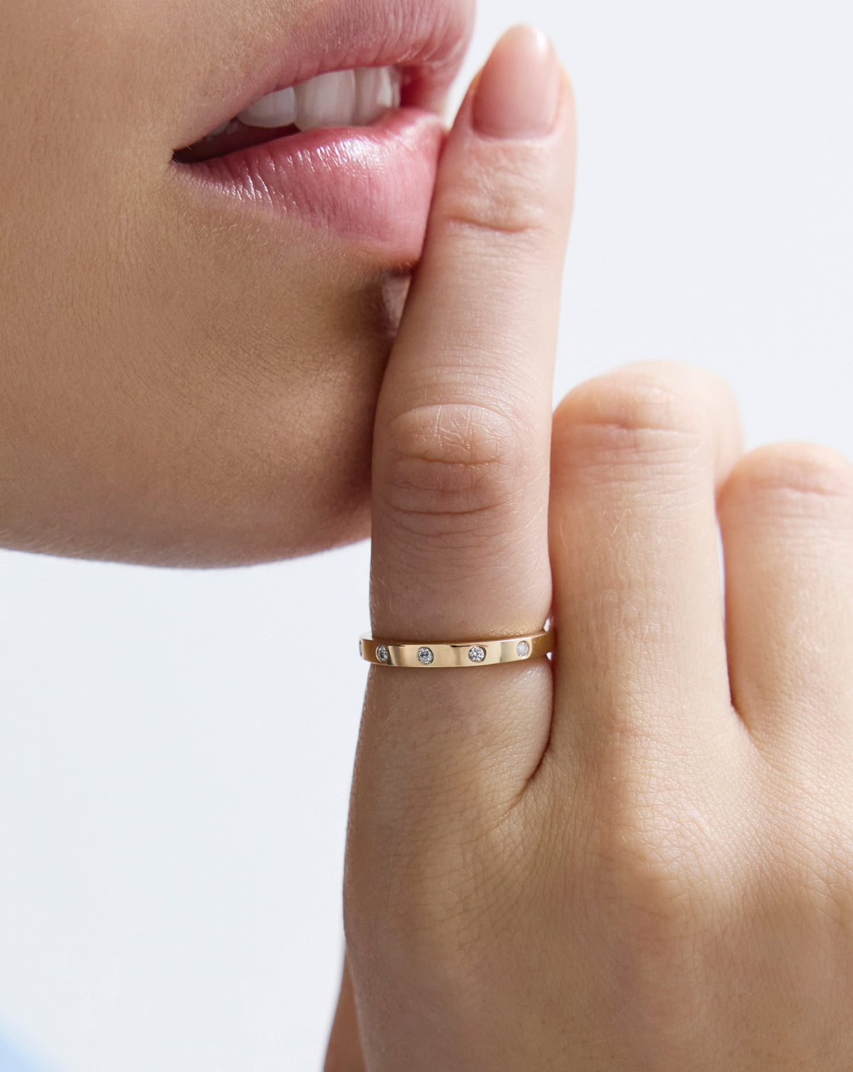 Inlay diamond ring worn on finger, showcasing 1.6mm band width and natural diamond placement