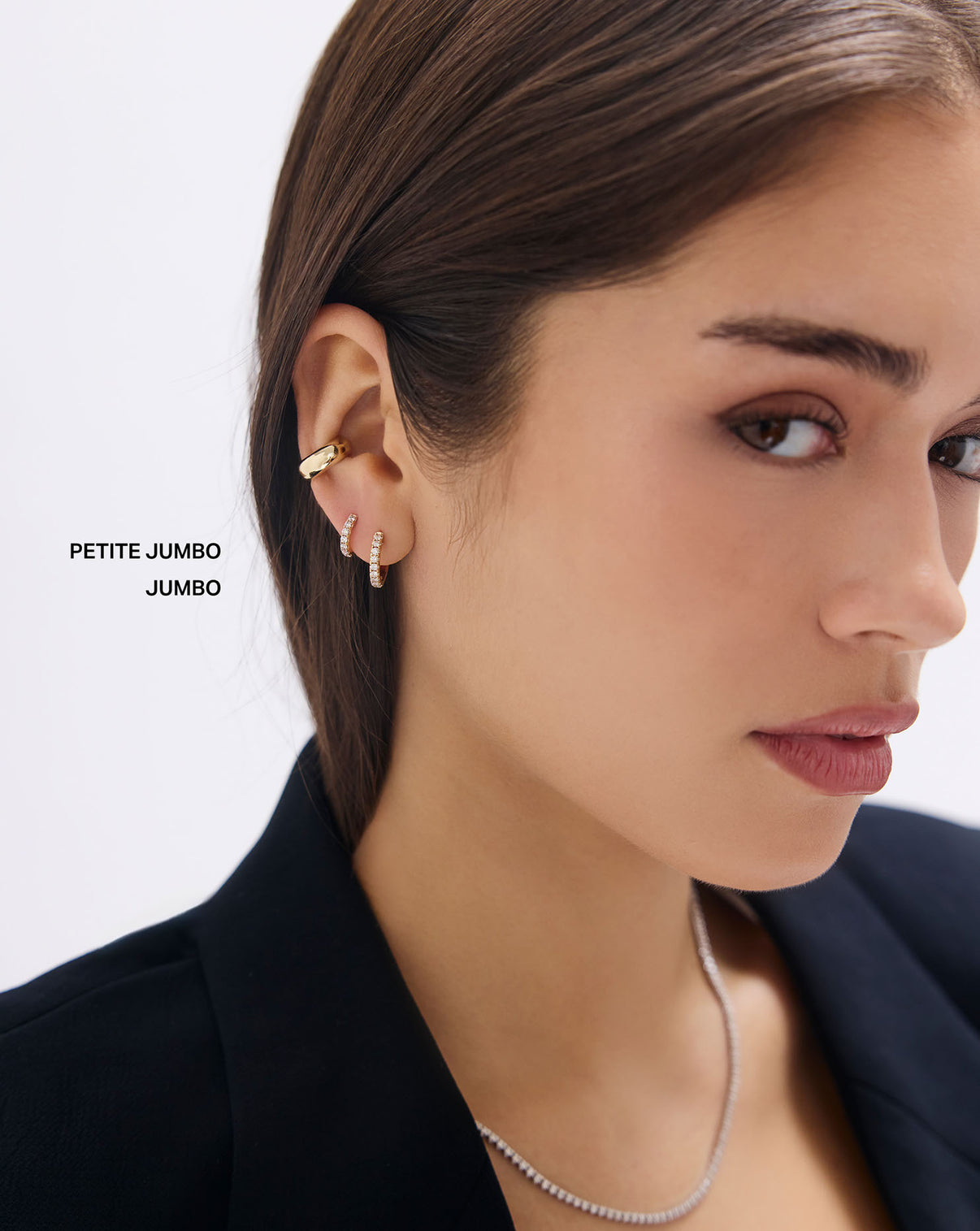 Close-up of model's ear featuring Jumbo Diamond Huggies with sparkling diamonds, demonstrating the perfect huggie fit