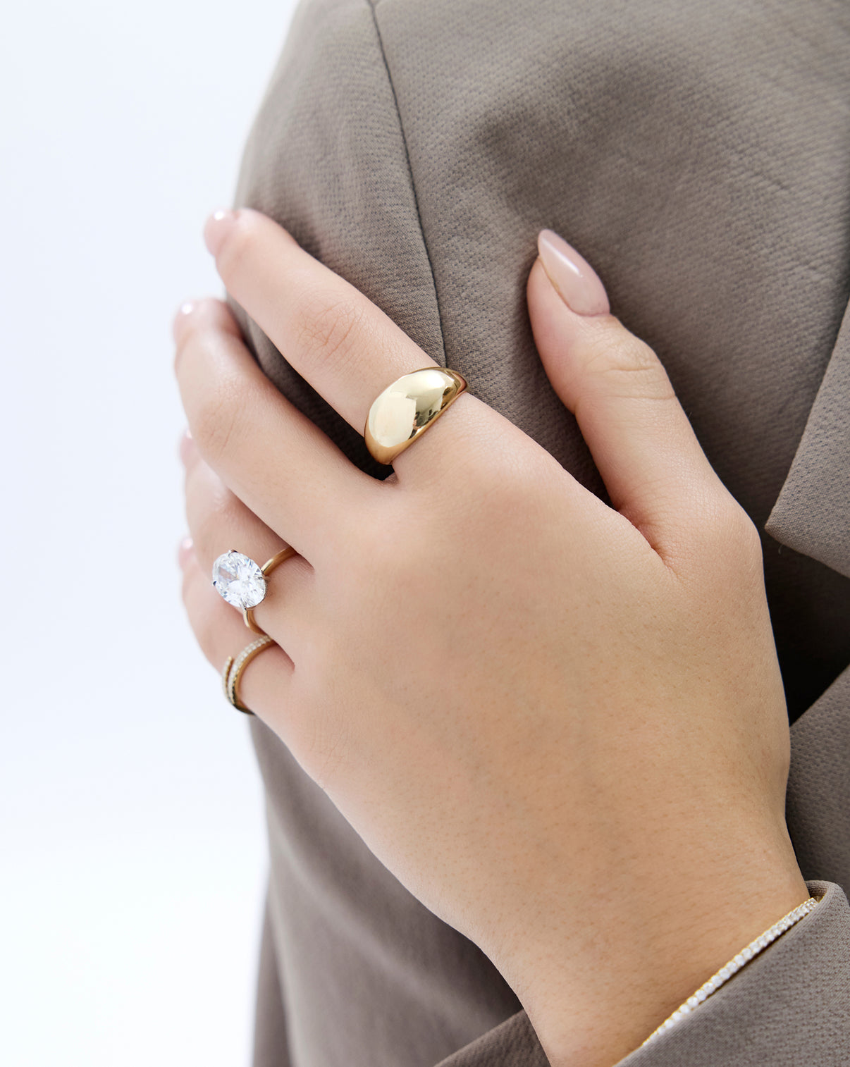 14k yellow gold jumbo gold cloud ring shown on model styled with some of our other best selling rings