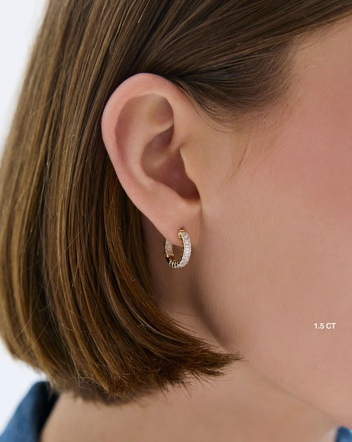 Model wearing gold emerald 1.5 carat lab diamond huggies earrings - Ring Concierge global