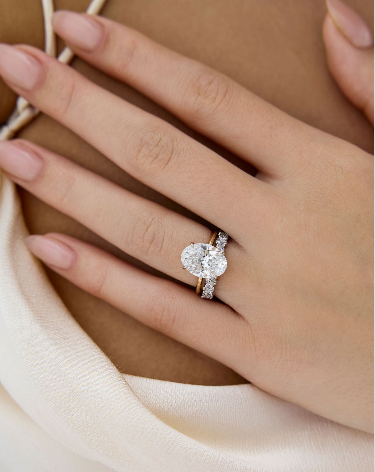 Ring Concierge Marquise Cluster Diamond Eternity Band Platinum on-model paired with oval diamond engagement ring