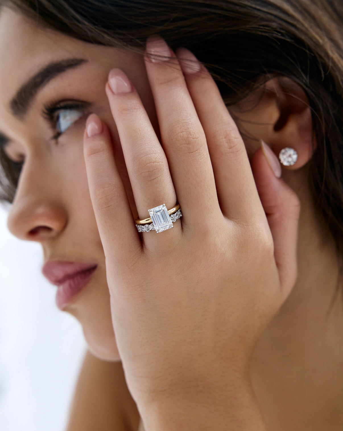 Close up of Marquise Cluster Diamond Eternity Band Platinum on-model paired with engagement ring