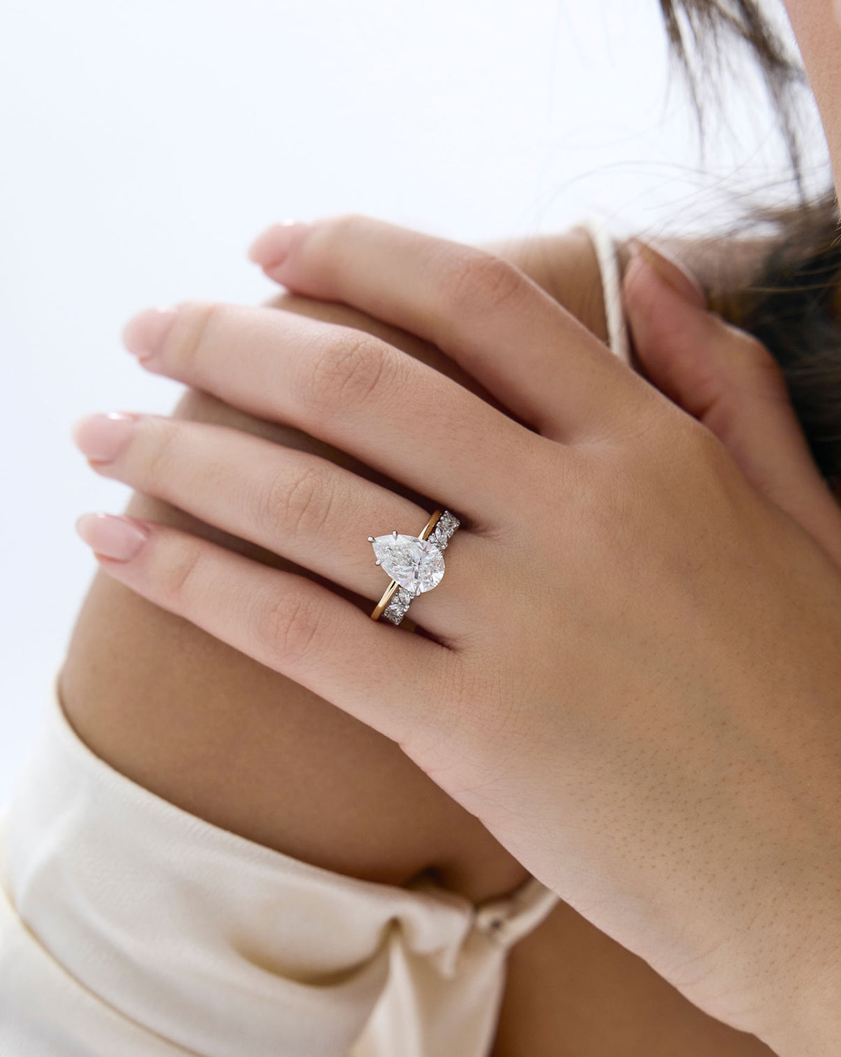 Ring Concierge Marquise Cluster Diamond Eternity Band Platinum on-model paired with pear shaped diamond engagement ring