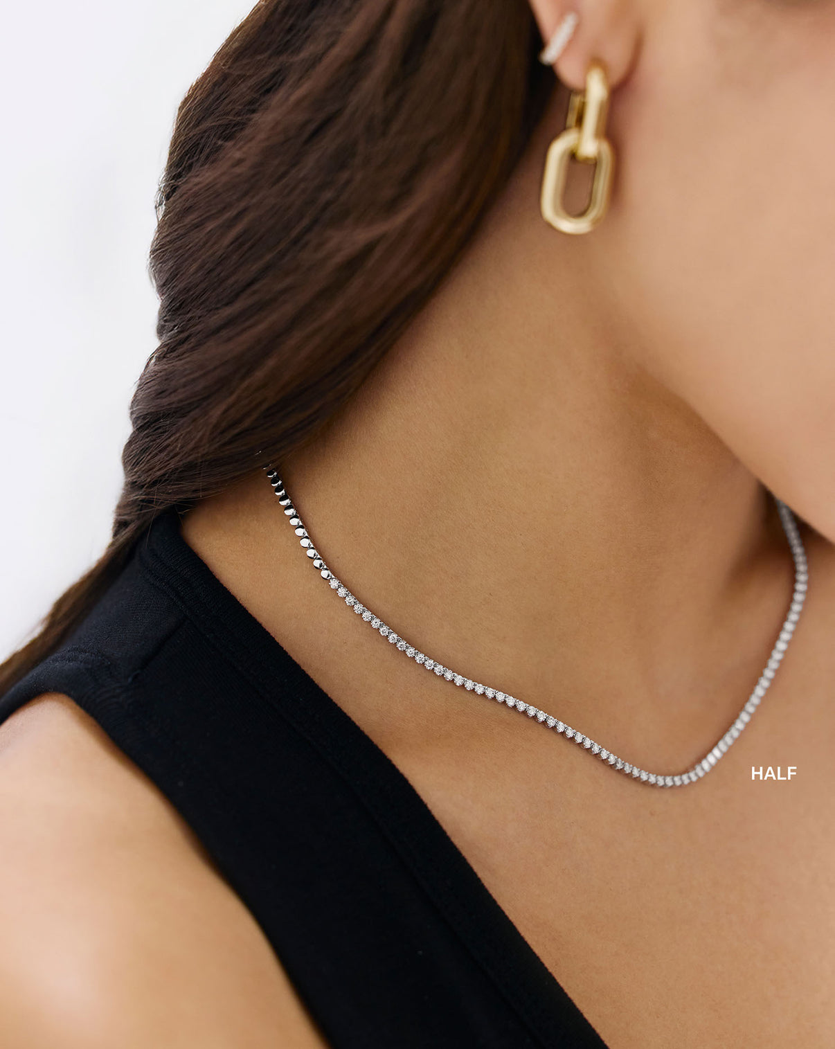 Profile view of model wearing Mini Diamond Tennis Necklace showing the necklace's elegant drape GLOBAL
