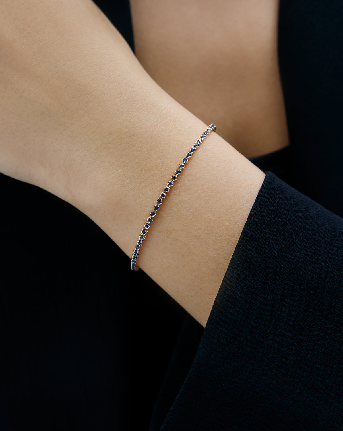 Mini Gemstone Tennis Bracelet Blue Sapphire half on model yellow gold 43895712776280