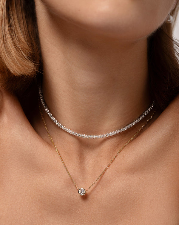 Half Carat Mixed Shapes Diamond Pendant Necklace in the round shape worn with the Multiway Tennis Diamond Necklace + Double Wrap Bracelet around model's neck