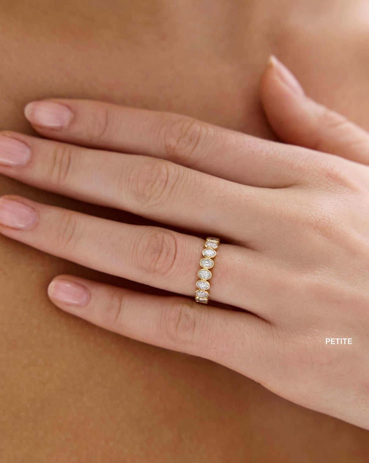 Model wearing Petite Oval Diamond Bezel Eternity Band in 14k Yellow Gold Global