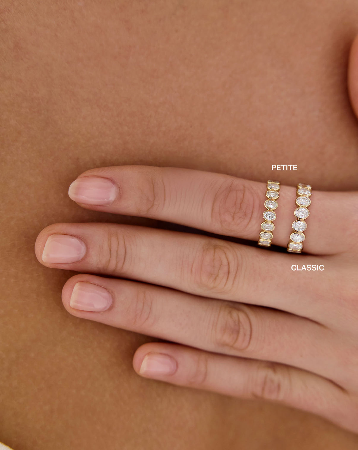 Model wearing 2 sizes Oval Diamond Bezel Eternity Band Rings in 14k Yellow Gold Global
