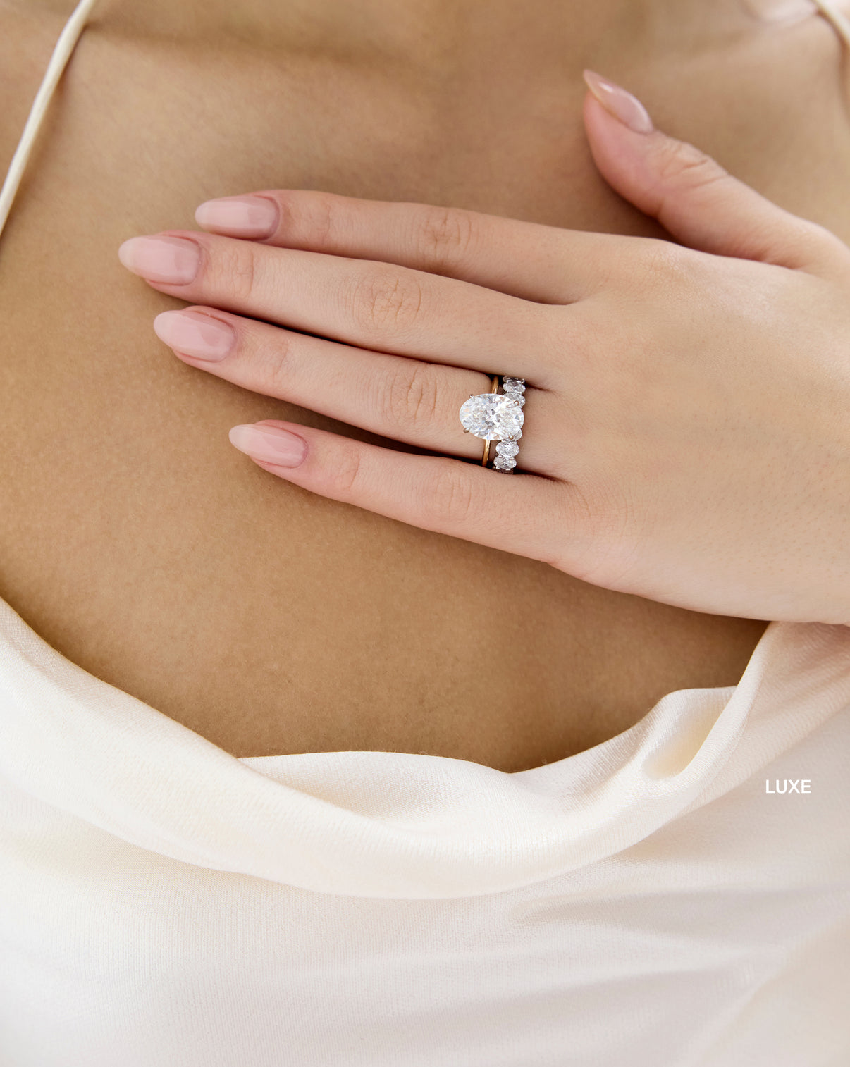 Luxe Oval Diamond Band paired with engagement ring worn by model - global