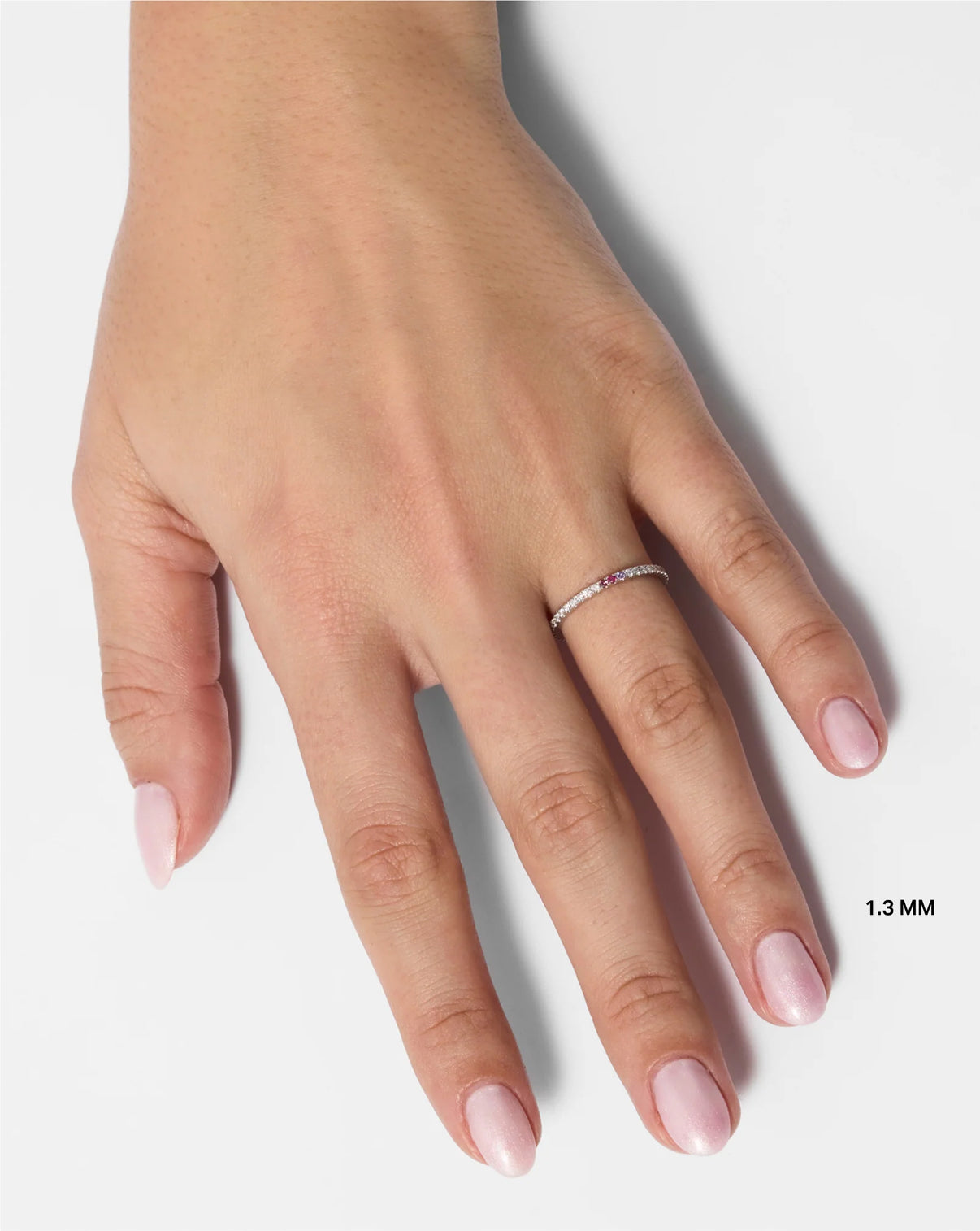 Model wearing 1.3 mm perfect pave with two gemstones global
