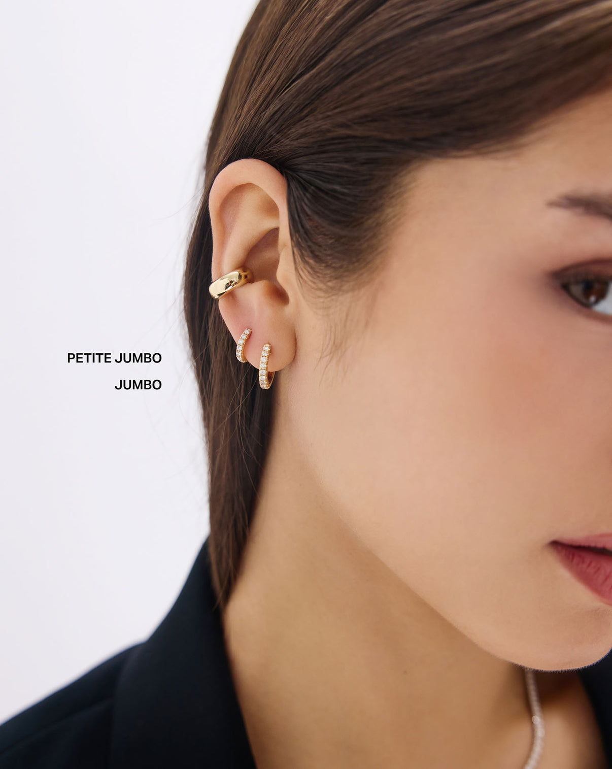 Model wearing 14k gold Petite Jumbo Diamond Huggies earrings in lifestyle setting