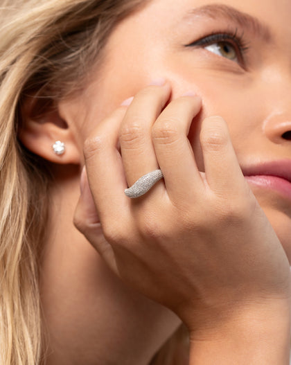 Model resting her face on hand wearing the Pavé Movement Cloud Ring