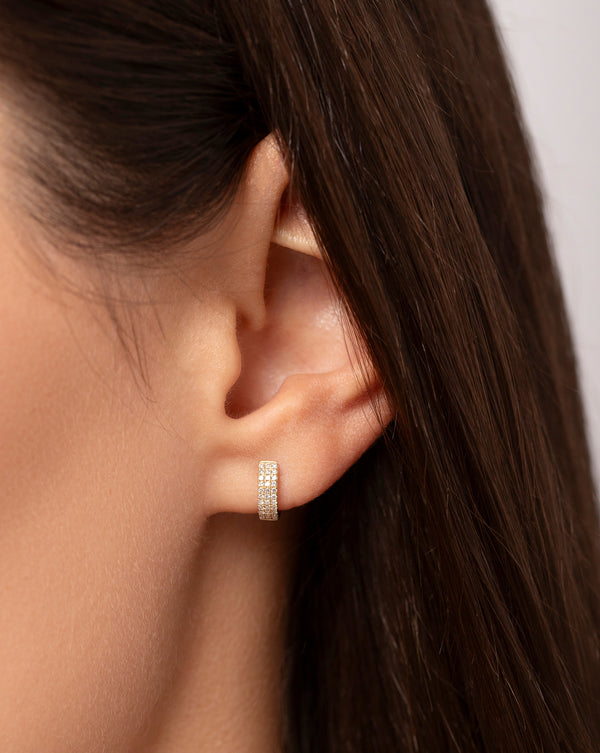 Close up image of the Petite Triple Row Huggies shown on ear of model