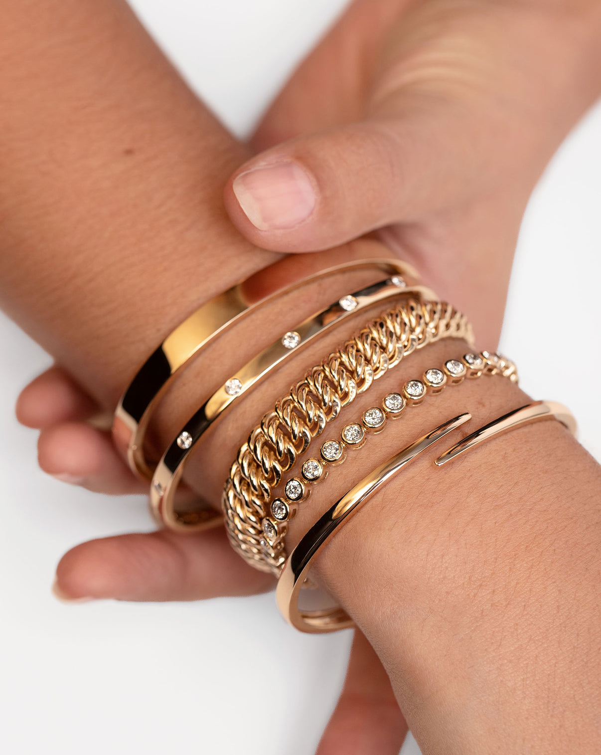 Ring Concierge Bold Gold Braided Chain Bracelet 14k Yellow Gold - on-model with finger showcasing the bracelet stack on opposite wrist