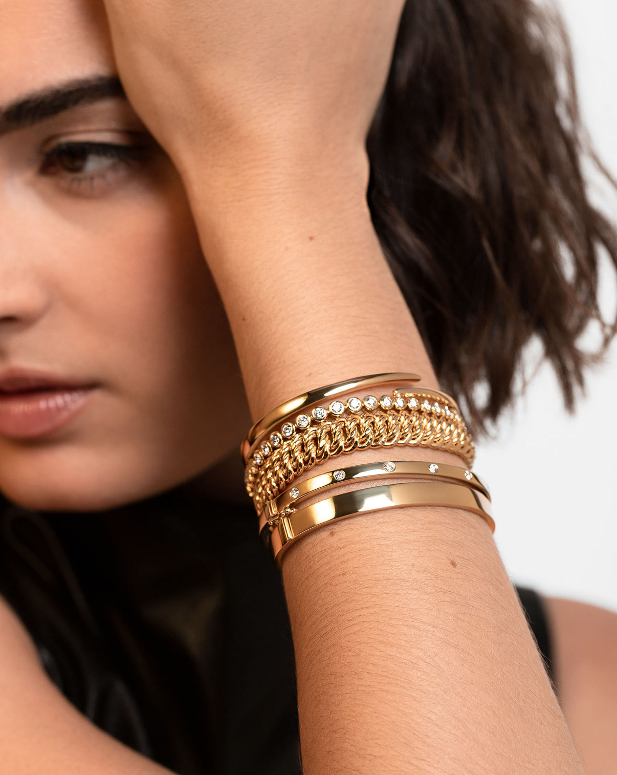 Ring Concierge Bold Gold Braided Chain Bracelet 14k Yellow Gold - on-model with bracelet stack of 5 other gold bracelets